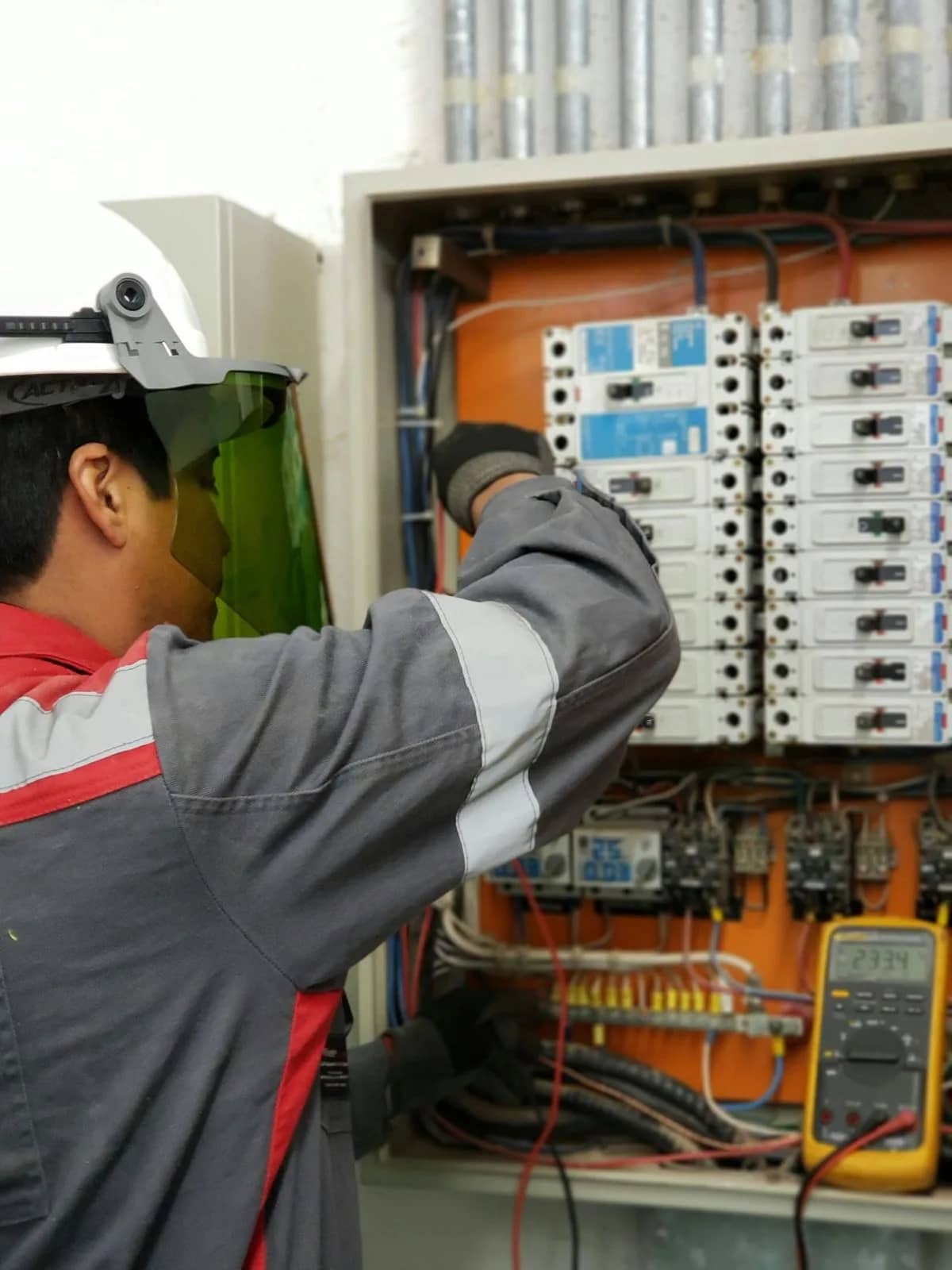 Engineer testing an electrical control panel